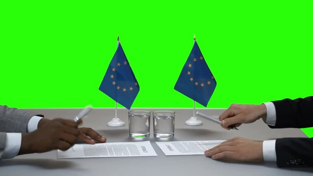 People signing documents. Handshake of two men. The more allies the better. EU politician takes on responsibility.