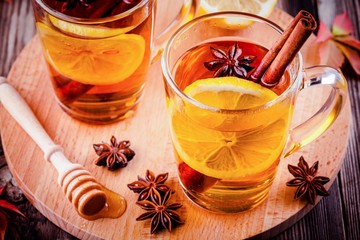 hot tea with lemon, anise and cinnamon in glass mugs