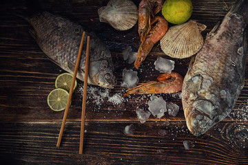 Food wooden background with Seafood, sticks, lime, salt. Copy sp