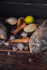 Food wooden background with Seafood, sticks, lime, salt. Copy sp