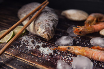 Food wooden background with Seafood, sticks, lime, salt. Copy sp