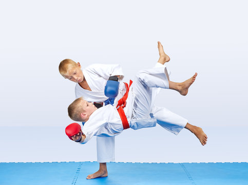Throws of judo are training athletes with red and blue overlays on his hands