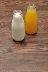 Milk and orange juice in bottles