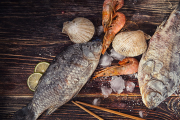 Food wooden background with Seafood, sticks, lime, salt. Copy sp