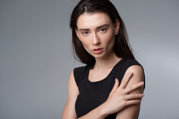 woman face isolated on light grey background with copyspace looking into camera