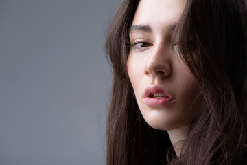 brunette portrait isolated on light grey background