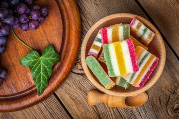 Colorful jelly candies in wooden bowl.