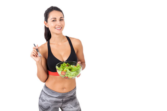 Smiling girl happily eating her salad