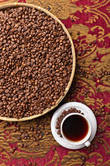 Cup of black coffee and  beans