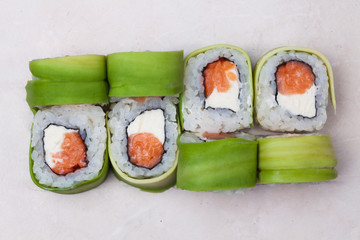 roll avocado and salmon on top isolated