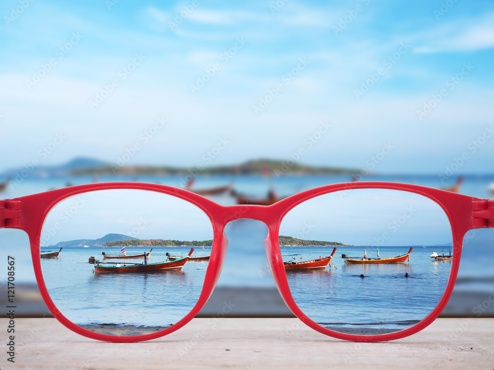 Wall mural Summer beach focused in red glasses lenses