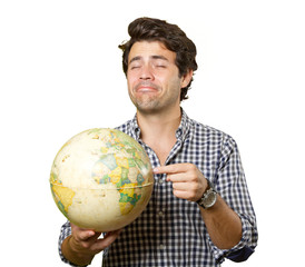 Young man isolated showing a globe