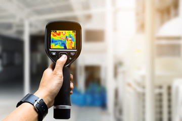 technician use thermal imaging camera to check temperature in fa - obrazy, fototapety, plakaty