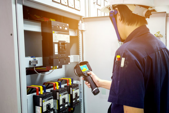 technician use thermal imaging camera to check temperature in fa