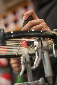 Stringing Machine. Detail of tennis stringer hands while holding awl and doing racket stringing