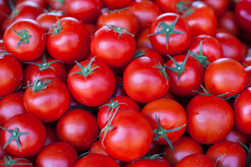 Close-up view of fresh tomatoes. Heap of  organic tomatoes on the market.