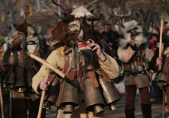 PERNIK, BULGARIA - JANUARY 30, 2016 - Masquerade festival Surva in Pernik, Bulgaria. People with mask called Kukeri dance and perform to scare the evil spirits