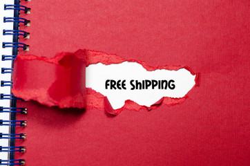 The word free shipping appearing behind torn paper