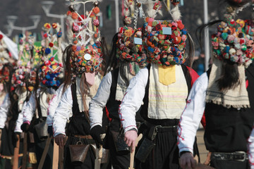 Fototapeta na wymiar PERNIK, BULGARIA - JANUARY 30, 2016 - Masquerade festival Surva in Pernik, Bulgaria. People with mask called Kukeri dance and perform to scare the evil spirits