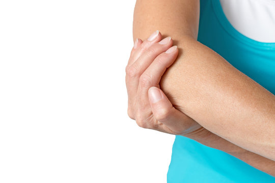 Middle Age Woman Is Holding Her Sore Elbow. All Is Isolated On The White Background. Empty Place For Your Text Is In The Left Half Of The Photo.