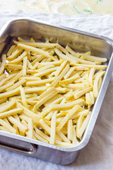 Baking pan of chips to be cooked in the oven