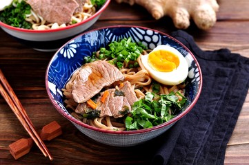 Soup with soba noodles, beef, ginger, green onions and egg.