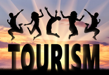 Silhouette people jumping over the word tourism