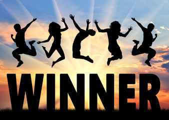Silhouette people jumping over word winner