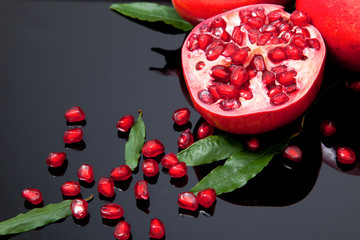 Piece of pomegranate fruit and pomegranate seeds