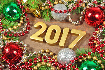 2017 year golden figures and spruce branch and Christmas decorat
