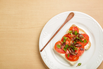 Clean food, Top view Watercress, Tomato slices and Whole Wheat Bread on white plate on wood background..