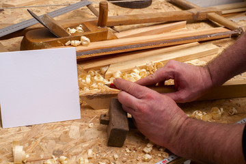 Carpenter tools on wooden table with sawdust.