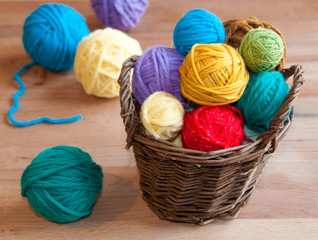 Many colorful wool balls in a basket