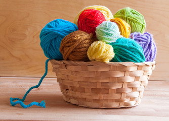 Many colorful wool balls in a basket