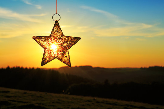 Christmas star and bright sun.