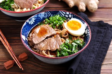 Soup with soba and ramen noodles, beef, ginger, green onions and egg.