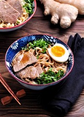 Soup with soba and ramen noodles, beef, ginger, green onions and egg.