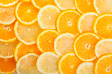 citrus background. juicy slices of lemon and orange cover the entire surface. 