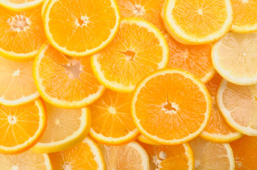 citrus background. juicy slices of lemon and orange cover the entire surface. 