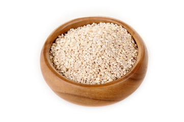 pearl barley in a wooden bowl. for healthy cooking ingredient