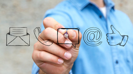 Businessman drawing manuscript contact icon with a pen © sdecoret