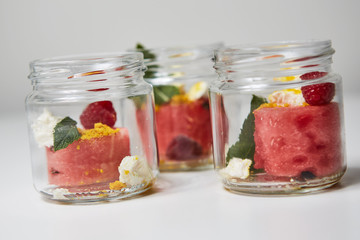 Watermelon with berries in a jar