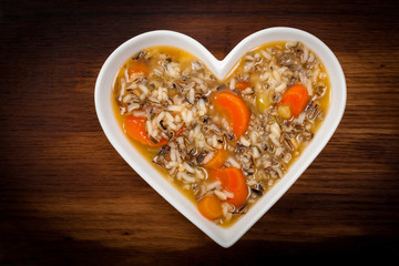 Vegetarian Wild Rice Soup in Heart Shaped Bowl. Selective focus.
