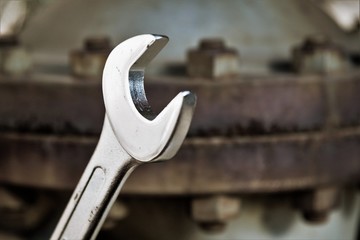 Shining new Wrench on a rusty bolt