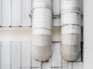 White smokestack for smoke out from kitchen. Chimney Installed on the wall of the building