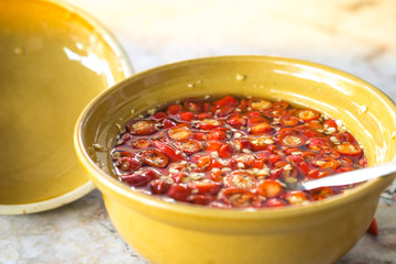 Chili and fish sauce mixed in yellow cup for seasoning thaifood