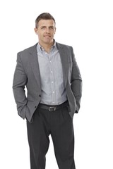 Businessman standing with hands in pockets