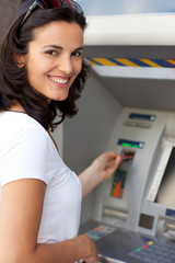 Fototapeta na wymiar Latin woman at ATM