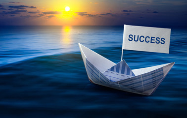 .Success word with business paper graph boat on sea.
