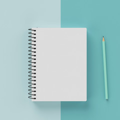 Minimal work space : sketchbook and green pastel pencil on green pastel background. Top view , flat lay